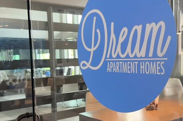 The E-Lounge at Dream Apartments with the Dream Apartment Homes logo on the glass door