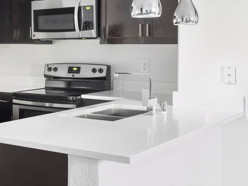 White quartz countertop, sink and pendant lights in a Dream kitchen